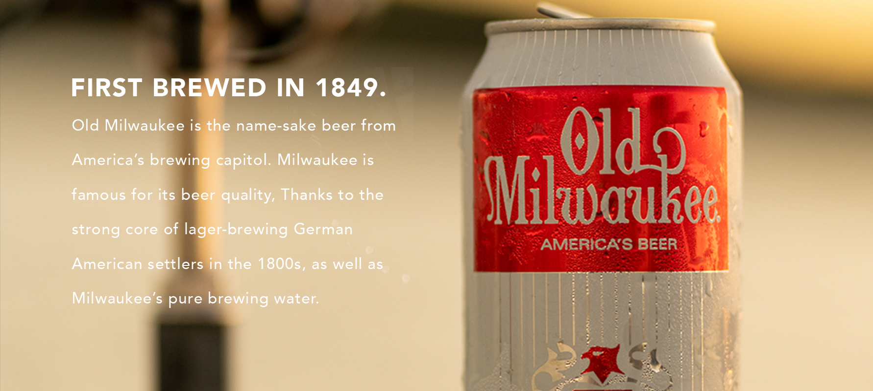 old milwaukee beer with golden blurred background and text next to it 